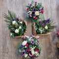 Four floral arrangements (two bouquets and two posies) featuring a mix of flowers from the casket spray you ordered.