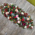 A 4ft double-ended coffin spray with a mix of red, peach, pink, and white flowers