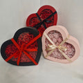 Heart-shaped boxes roses on a light gray background