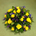 A larger posy arrangement of yellow roses with blue and purple flowers, approximately 16 inches in diameter.